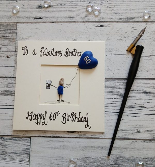 Luxury pebble art card 60th card for a brother, handwritten using black ink, To a fabulous Brother Happy 60th birthday, male pebble figure holding a beer and a blue heart balloon. Created on cream card.