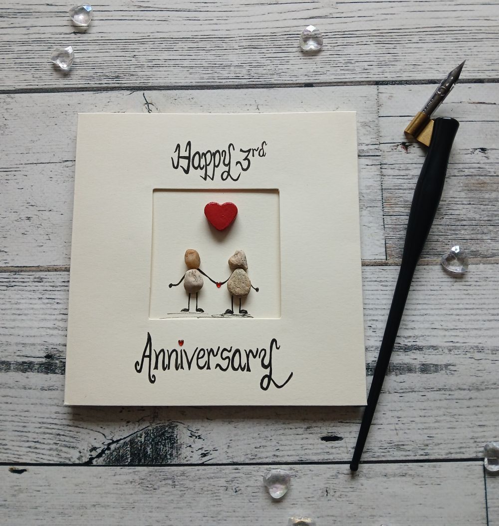 Anniversary-card-any-anniversary-wedding-anniversary-card-3 Luxury anniversary card for any anniversary, a pair of pebble figures holding hands, above the couple a red heart. Created on cream card