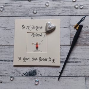 30th wedding card for husband, pebble art pearl card with pearl coloured pebble heart. Handwritten in black ink, To my gorgeous husband, 30 years down forever to go. Created on cream card.