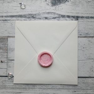 Pink self-adhesive wax seal to put onto the envelope